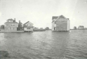 The building that would become the Dreamland being floated across Nantucket Harbor.
